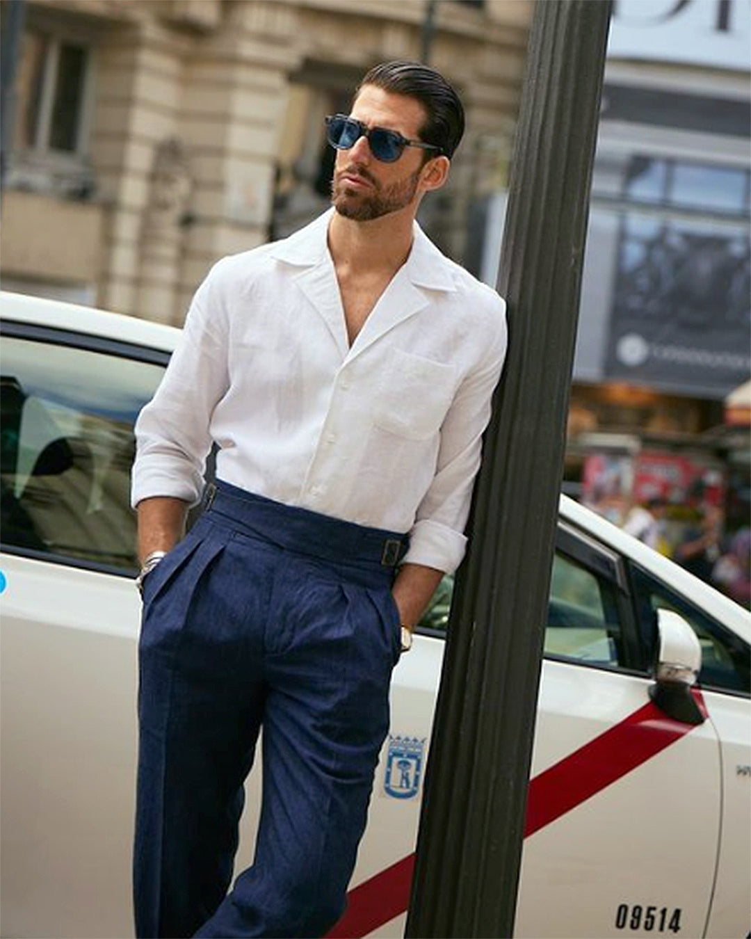 Male model outside wearing custom linen Gurkha pants for men by Luxire in dark indigo