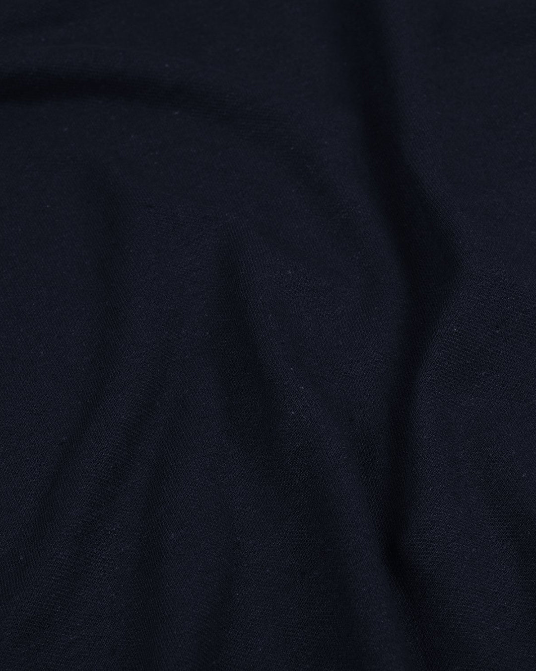 Close up of the custom oxford polo shirt for men by Luxire in navy