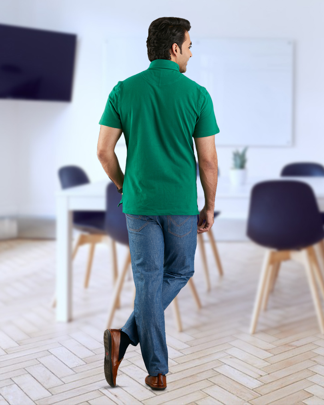 Back of model wearing the custom oxford polo shirt for men by Luxire in racing green