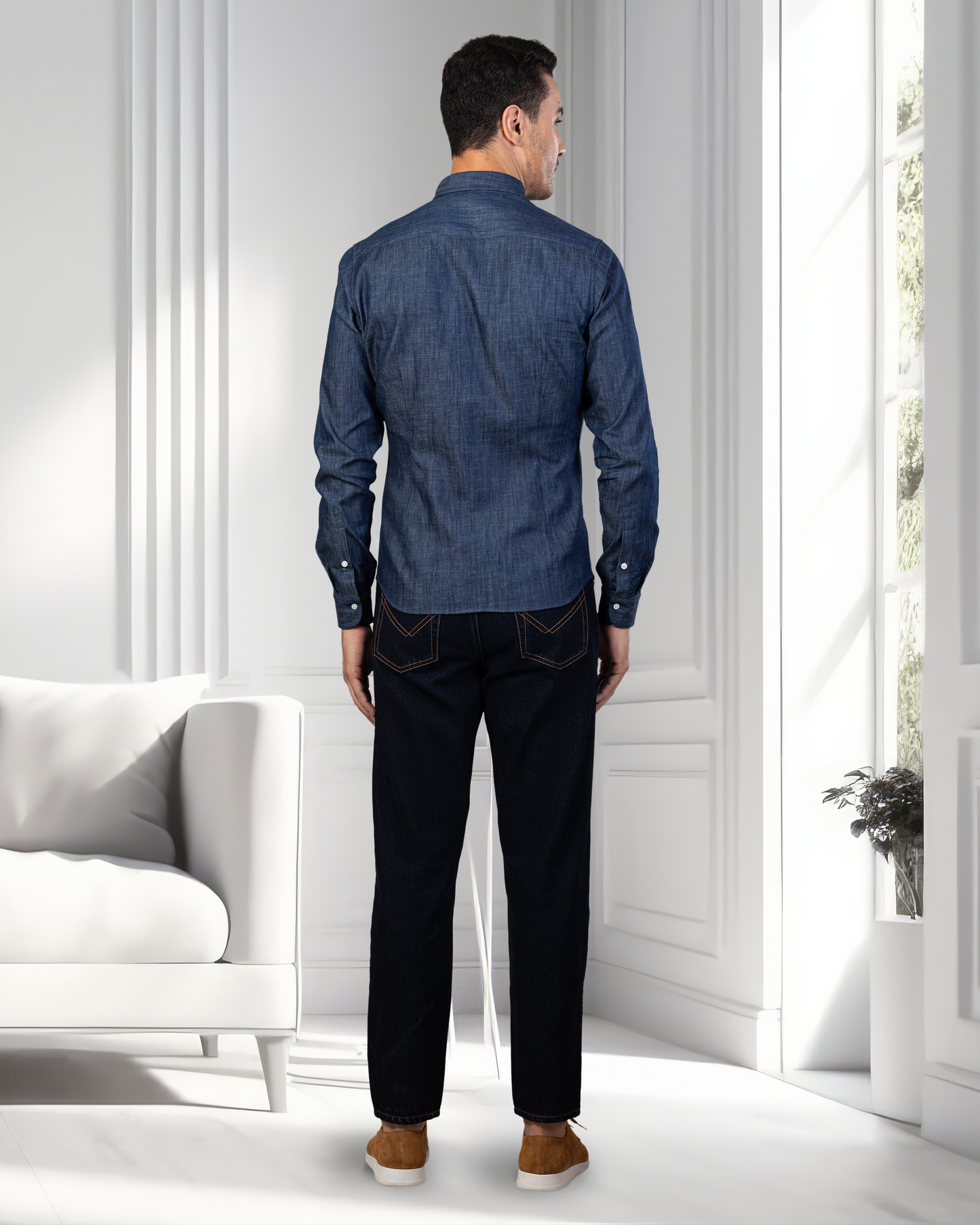 Back of model wearing mens fade washed jeans by Luxire in dark indigo