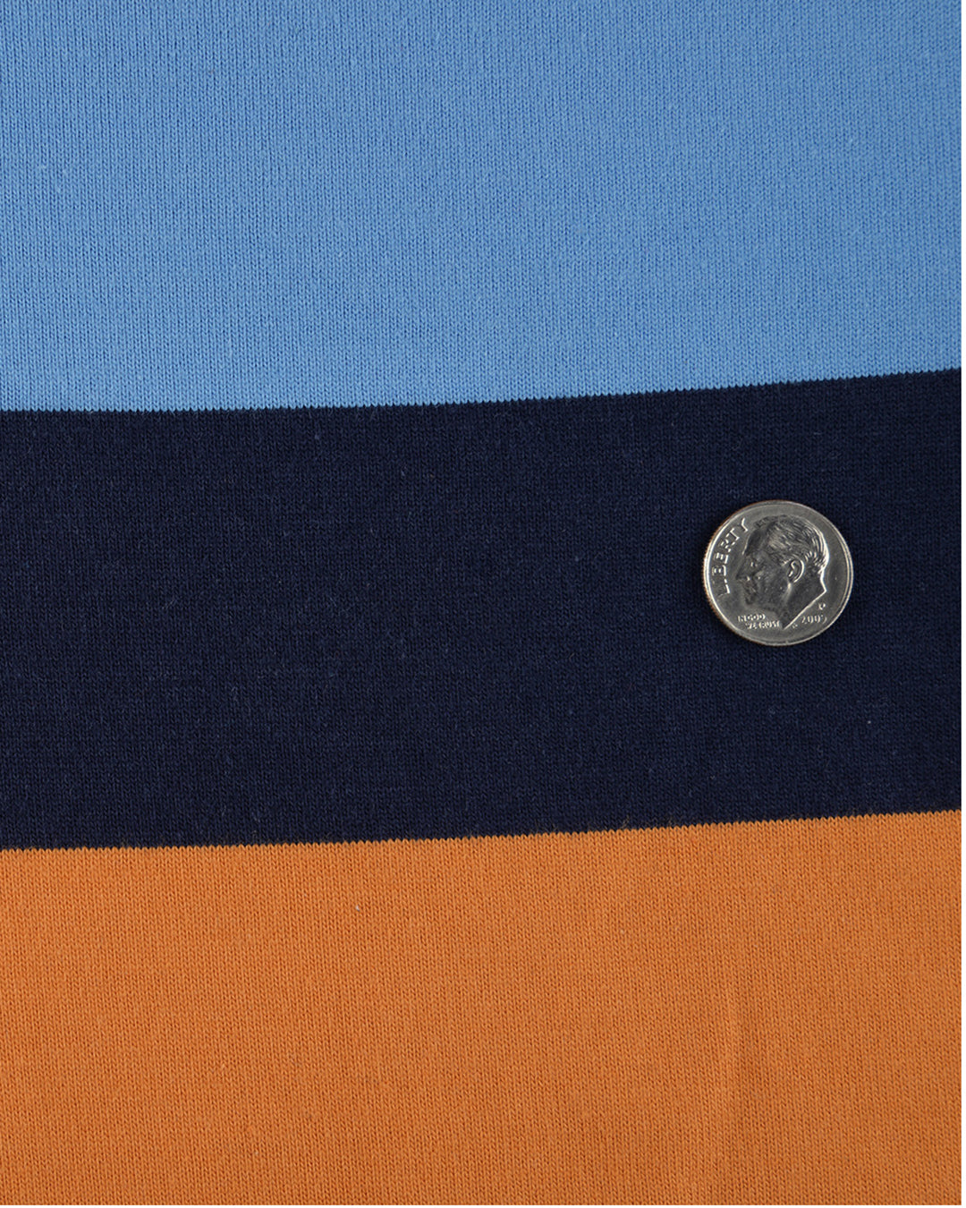 Close up of the custom oxford polo shirt for men by Luxire with navy blue and orange stripes 2