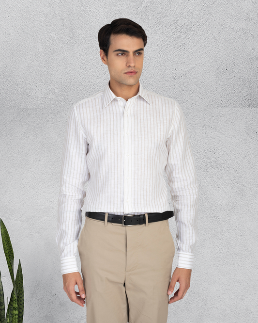Model wearing the custom linen shirt for men in white with ecru stripes by Luxire Clothing