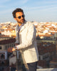 Model outside wearing the linen shirt jacket for men by Luxire in cream wearing sunglasses 11